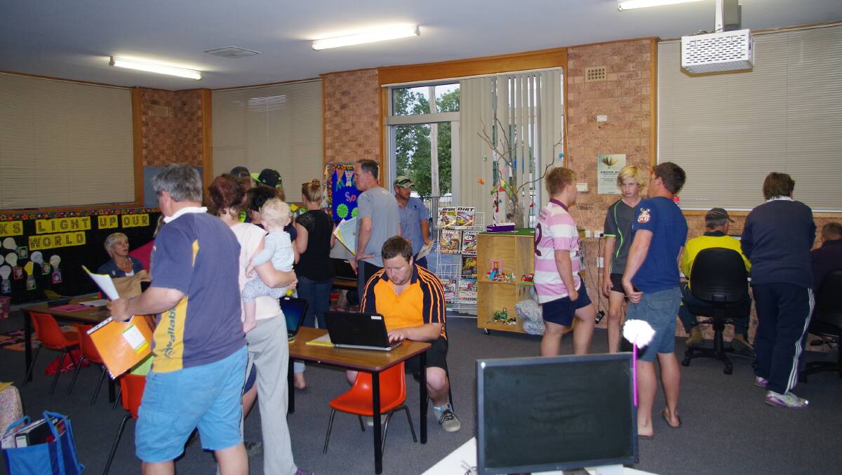 HIVE OF ACTIVITY: The Trinity Catholic Primary School library was a busy place on the night of touch football registration with everything been done online. Picture: John McLaurin.