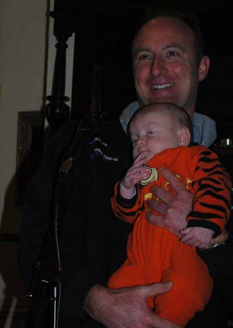 All ages are welcome at A Brush with Poetry. Here Tumut poet John Peel introduces baby Geoffrey to the microphone.
