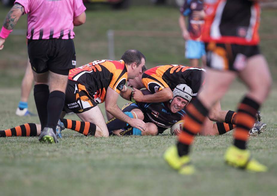Binalong's Beau O'Mara (with headguard) being pinned down by the Tigers in Binalong's 58-22 loss to Canowindra. Picture: Riva Potter.
