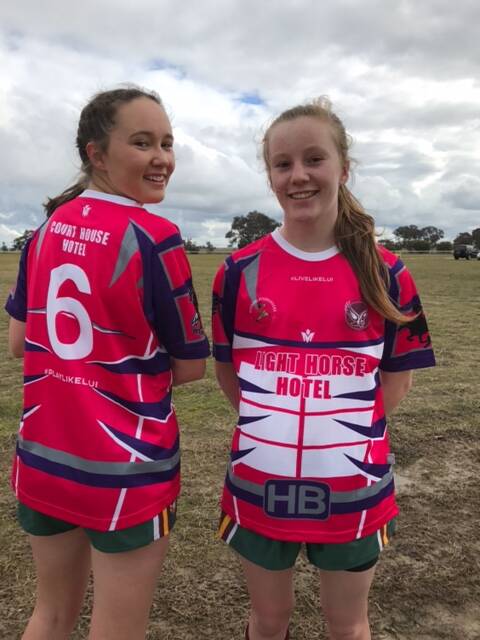 IN THE PINK: Abbey Davis and Bridie Minehan model the custom-designed pink jerseys that will be up for auction on Saturday.