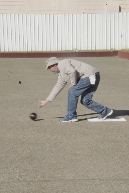 Craig Cooper shows us how it's done during Mufti Bowls on Sunday morning. He and Robert Bates were the proud winners of the chooks.