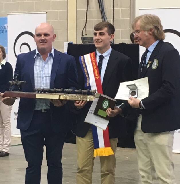 Sam Phillips (centre) was awarded two trophies, a sash and a cash prize after winning first in the State Final Merino Junior Judging event at the Sydney Royal Easter show.