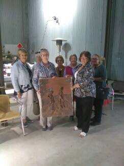 Fay Valerius presents the Land Army plaque to the ladies from Goolagong.