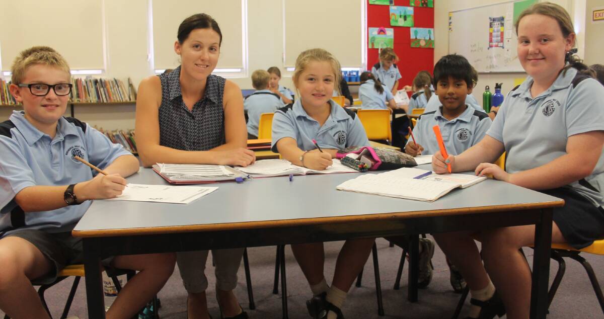 DEDICATED: Murrumburrah Public School teacher Ashleigh Humphreys volunteers her Monday afternoon to help students including Bradley Davis, Molly Glover, Miguel Whittington and Tara Parker. Picture: Harrison Vesey