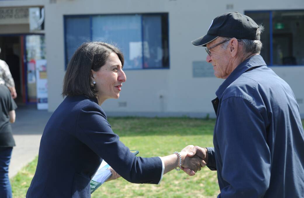 NSW premier Gladys Berejiklian greets a voter in Griffith on Saturday.