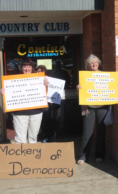 STANDING STRONG: Residents stage a silent protest with placards at last Friday's public enquiry. Picture: Jennette Lees 
