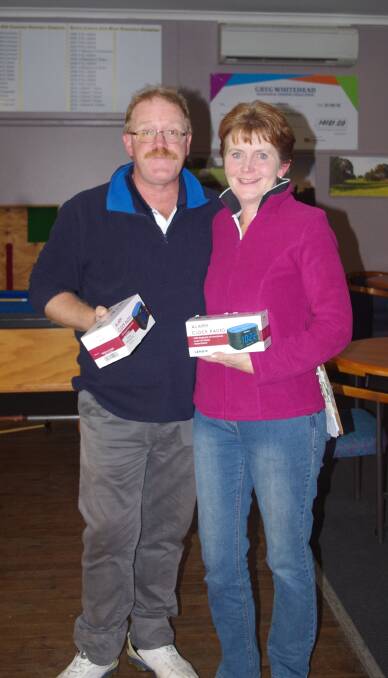 HAPPY WINNERS: Craig and Toni Filmer celebrate with their winnings after Saturday's golf. The pair were runners up in the mixed/medley division with 44. Picture: Jody Potts