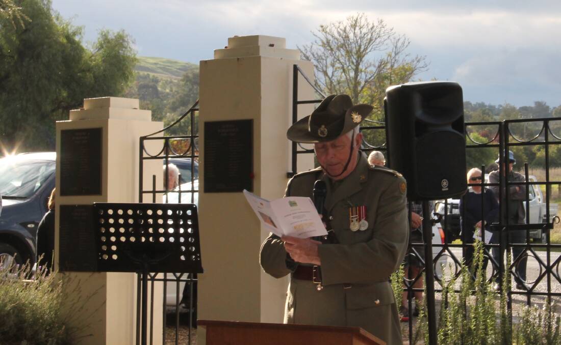 COMMEMORATION: Father Bernie Hennessy, Army Chaplain and Parish Priest Gundagai and administrator Jugiong Parish at the Memorial Gates in Jugiong on Saturday. 