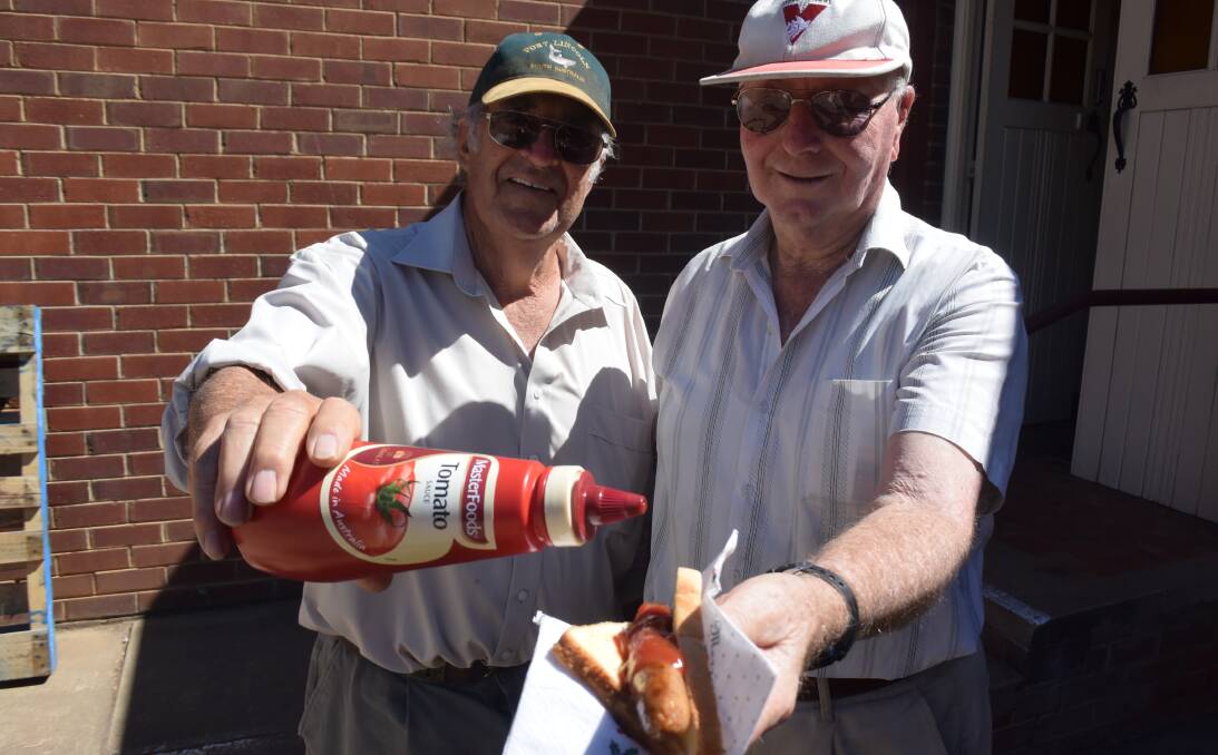 GOOD TUCKER: Peter Carn and Phil Sheather manning the barbecue at Wesley Uniting Church. Picture: Brodie Owen