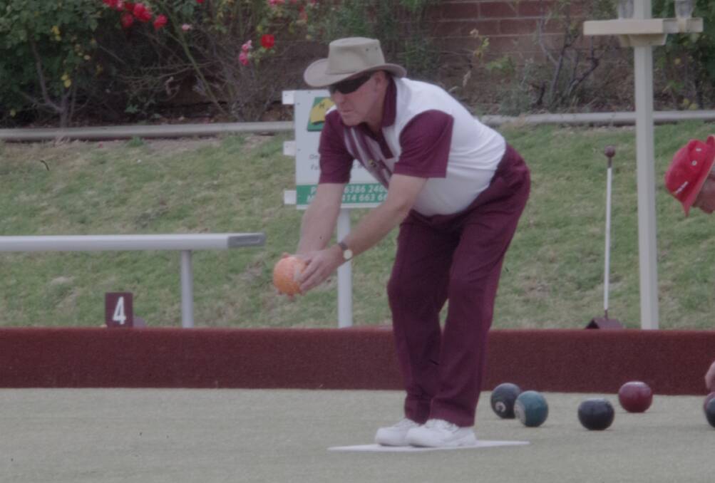 ON A ROLL: Brian Gibson lines up a shot in the Men's Triples Championship at the Harden Bowling Club on Sunday afternoon.