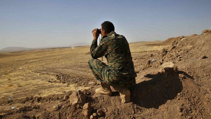 A Kurdish fighter monitors Islamic State positions at the Khazir frontline leading to Mosul. Photo: Ahmed Jadallah