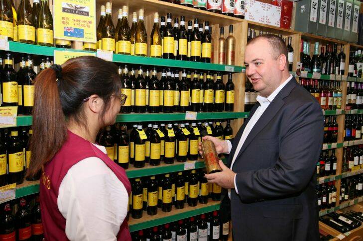 Peter Dixon, managing director of North Asia and Global Travel Retail at Treasury Wine Estates talks to a saleswoman at Jenny Lou's Shop in Beijing on May 18, 2017. Australian wine exports to China grew 43% to the end of March 2017. Peter Dixon, managing director of Treasury Wine Estate for Kirsty Needham's report of Australian business in China. Pic by Sanghee Liu?? May 18, 2017 at Jenny Lou's Shop in Beijing Photo: Sanghee Liu