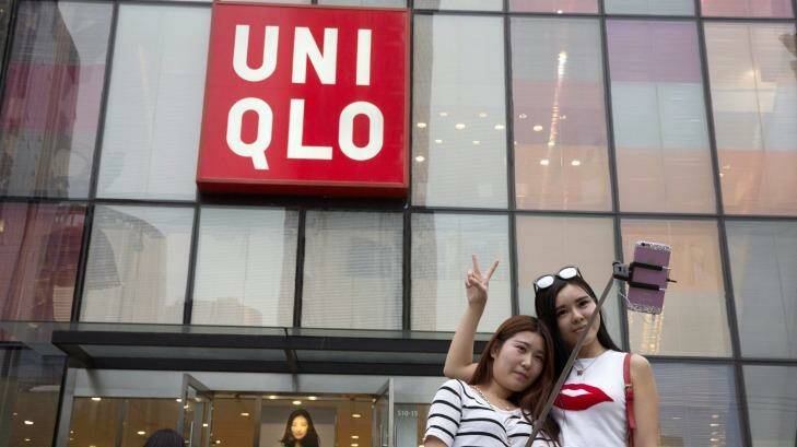Chinese women take a selfie outside the Uniqlo store in Beijing where a steamy video purportedly taken inside one of its fitting room showing a couple apparently having sex was filmed. Photo: Ng Han Guan