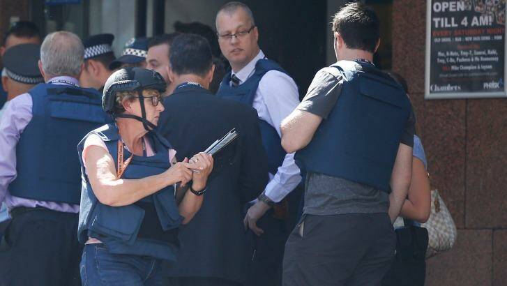 Police at the scene of the siege this afternoon.  Photo: Daniel Munoz