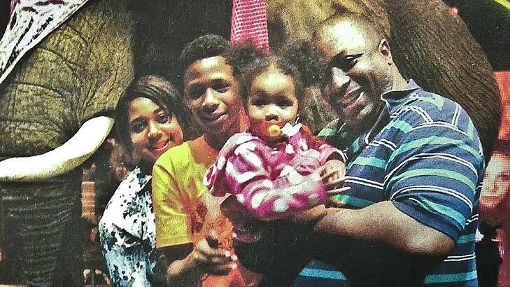 Family man: Questions raised over the tactics used by New York police to bring down a .9 metre, 159kg Eric Garner, seen her with some of his children.
