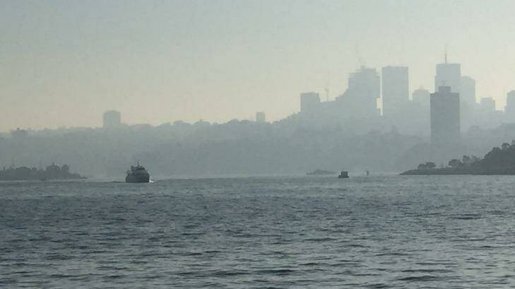 Haze hangs over the harbour because of controlled burns in Sydney's west, north and south. More is planned for this weekend.  Photo: Fairfax Media