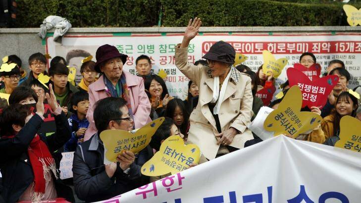 Kim Bok-dong (hand raised), who was pressed into sex slavery by the Japanese army, greets the weekly "Wednesday protest" which has been running for 23 years at Japan's embassy in Seoul. Photo: Woohae Cho