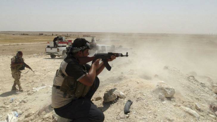 Tribal fighters engage with the Islamic State near the town of Haditha, north-west of Baghdad. Photo: Osama Al-dulaimi