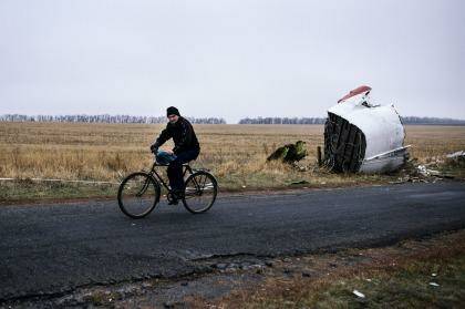 A man rides his bike at the MH17 crash site 80km east of Donetsk last week. Photo: Dimitar Dilkoff