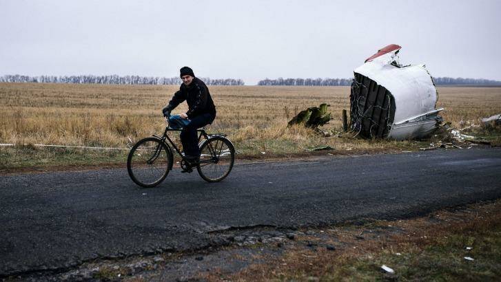 A man rides his bike at the MH17 crash site 80km east of Donetsk last week. Photo: Dimitar Dilkoff