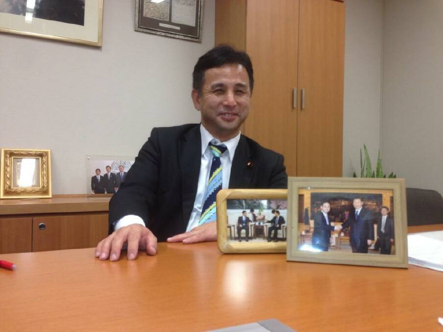 Mending fences: Kiyohiko Toyama at his office in Tokyo, with framed pictures of his meetings with Chinese President Xi Jinping and Vice-President Li Yuanchao. Photo: John Garnaut