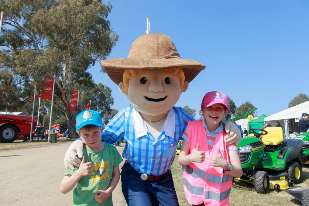 EDUCATE: George the Farmer with Charlie and Willough Dunn. George teaches children about farming and producing. Picture: SIMON BAYLISS