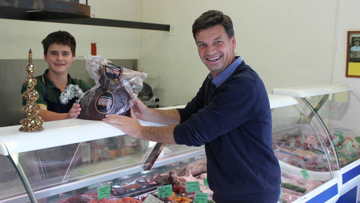 "We have some of the biggest pork producers in Australia in the Hume electorate and I encourage shoppers to buy some Hume produce for the Christmas table," Angus Taylor said this week, He is pictured with Gunning Meats apprentice butcher Andrew Robinson.