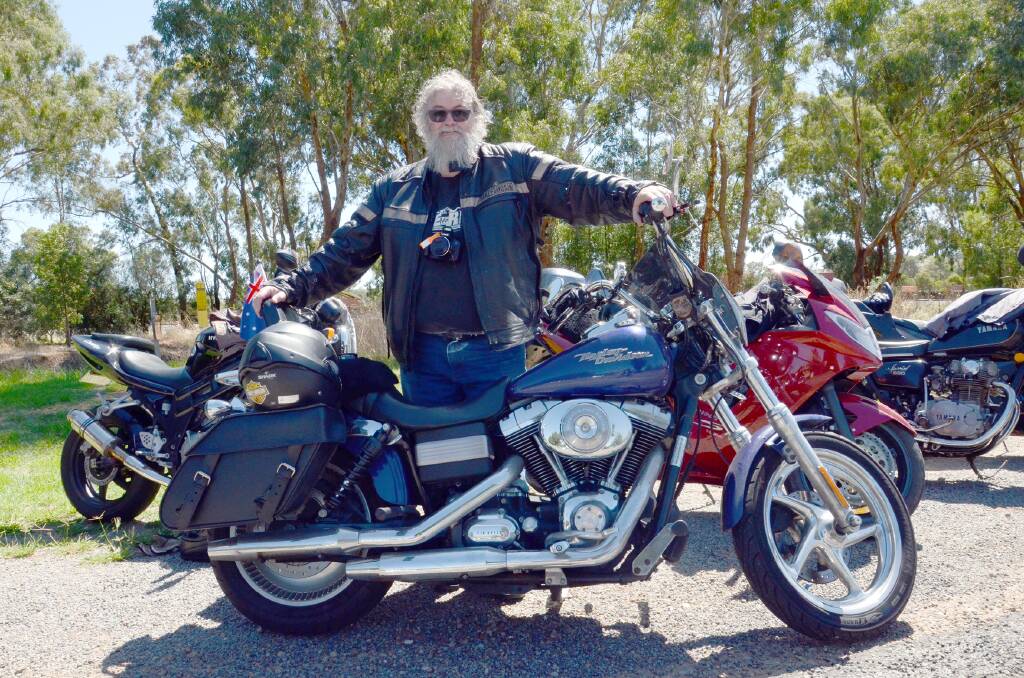 KEEN RIDER: Greg "Loaf" Risk and his Harley Davidson is one of the hundreds of riders at the first stop on the Junee Poker Run. Picture: Declan Rurenga