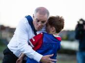 Prime Minister Scott Morrison accidentally crash-tackled under 8s football player, Luca Fauvette, on Wednesday afternoon in Devonport, Tasmania. Picture: Eve Woodhouse