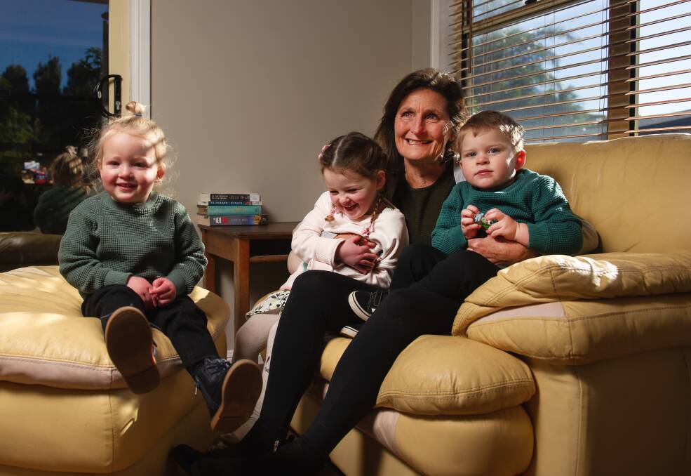Former Newcastle Herald journalist Joanne McCarthy at home with her three grandchildren: Aria Jury, 3: Finn Jury, 2, and Billy Jury, 2. Picture: Marina Neil.
