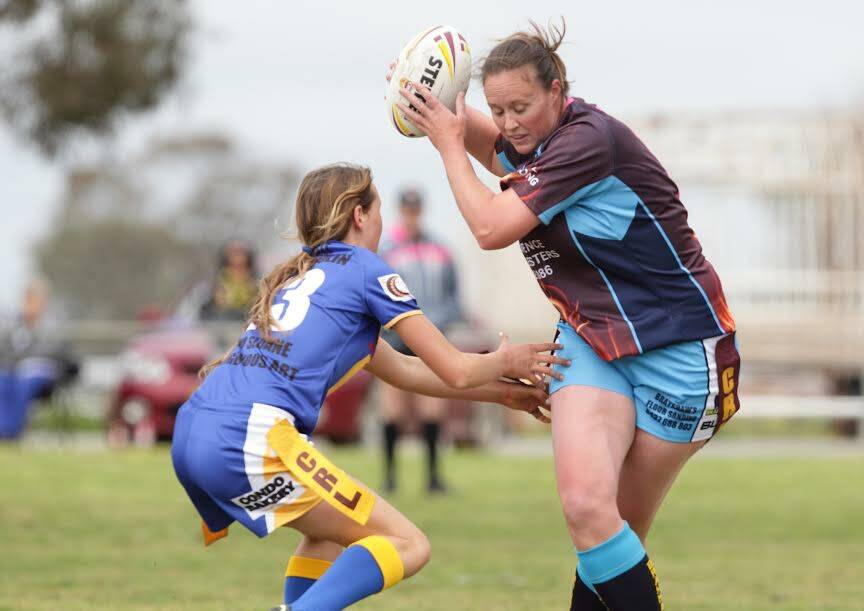 AT HER ELUSIVE BEST: Jersey Girl Madeline Brayshaw tries to avoid a Condobolin tag in the qualifying final played at Condobolin. Picture: Susan Meli.