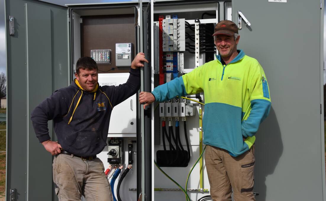 Bright sparks: Electricians Andrew Jones and Robert Scott in front of their work at the Murrumburrah Showground. Picture: Jody Potts