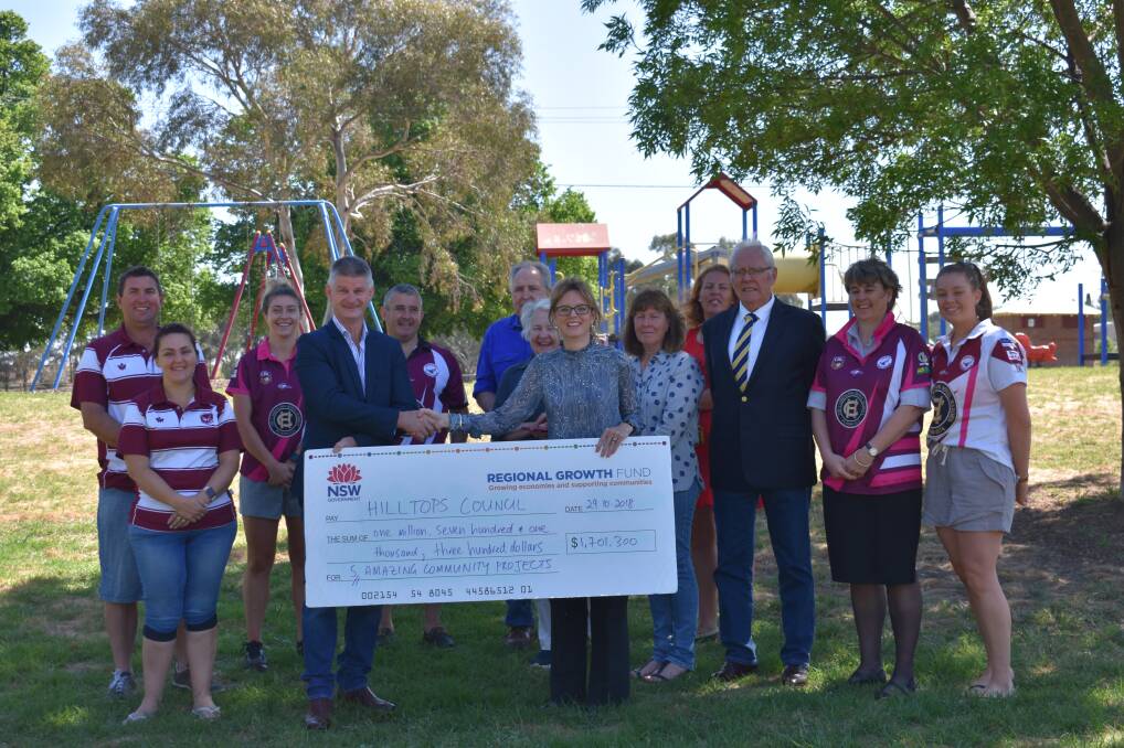 Hilltops Council Mayor accepting a cheque from Member for Cootamundra, Steph Cooke, while Hilltops Councillor John Horton and members of local community groups look on. Picture: Jody Potts