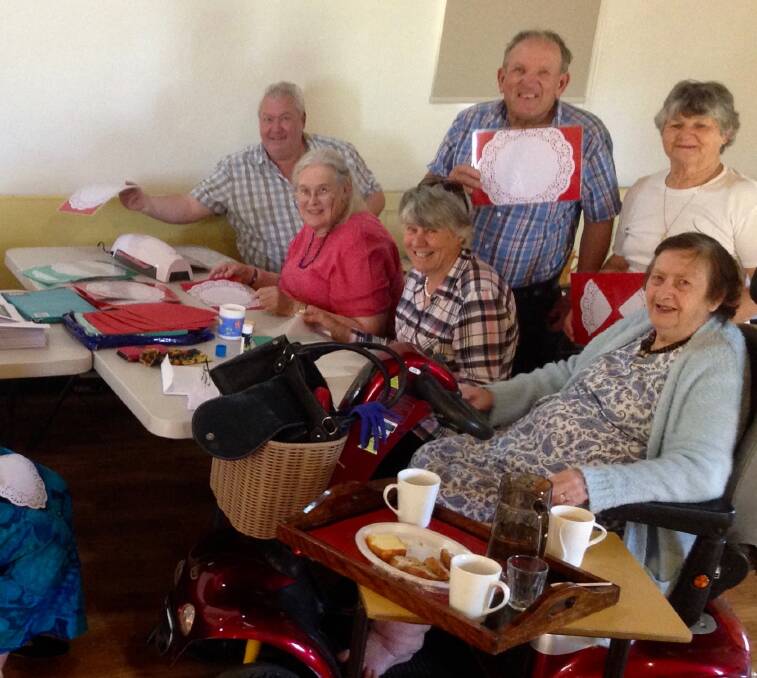 Some of the folk at the Harden/Galong Uniting Church preparing laminated calendars, placemats and Christmas cards. Picture: contributed