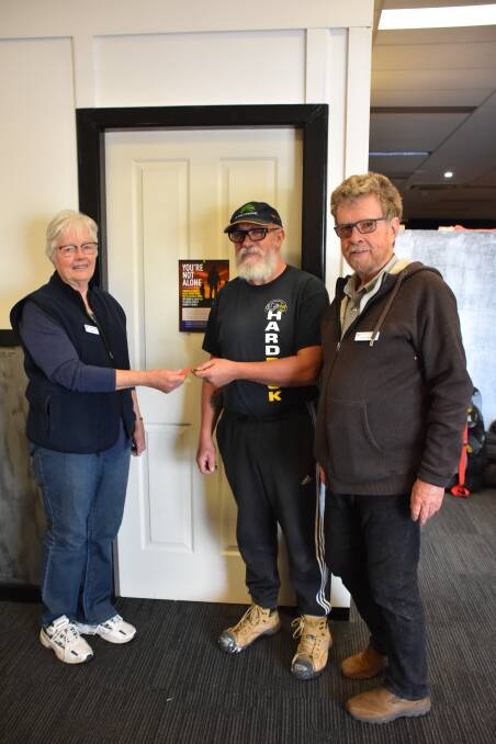 Harden St Vincent De Paul Conference manager Linda Barry receives the keys for their new office from Glenn Stewart, Manager of the Hard Rock Gym and Christopher Bishop. 