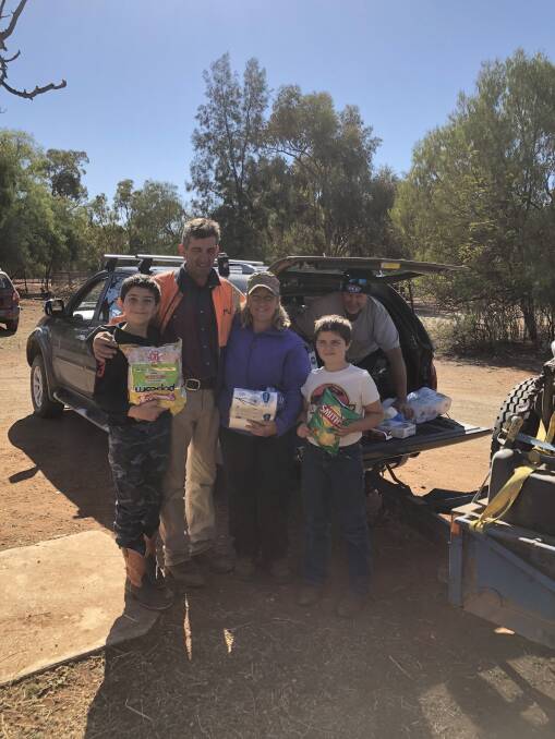 Drought relief: The O'Brien family from Tottenham Harrison, Justin, Kate and James with Gus Weekes from Molong in the ute. Picture: contributed.