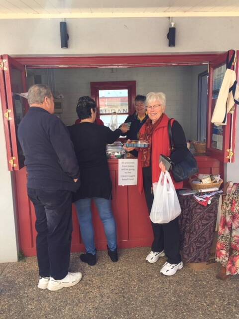 Street stall: Linda Barry was very happy with her purchase, knowing it will be helping to support the farmers. Picture: contributed.
