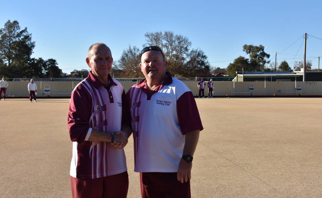 Still friends - Terry Ricketts shakes hands with Chris Hocking after a recent match at the Harden Bowling Club