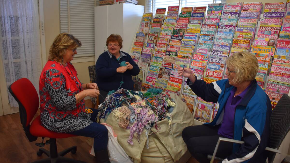 Harden CWA members De Farrell and Ros Bickford up for a chat while they wind wool. Picture: Jody Potts