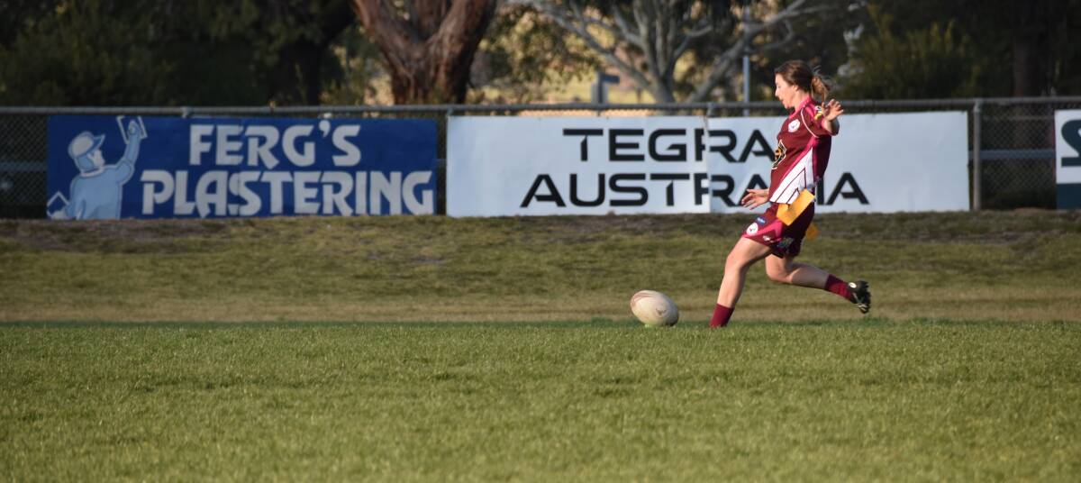Emma James goes in for a kick at a recent match at McLean Oval. Emma's deadly aim is one of the keys to the Hawkettes' success this season. Picture: Jody Potts