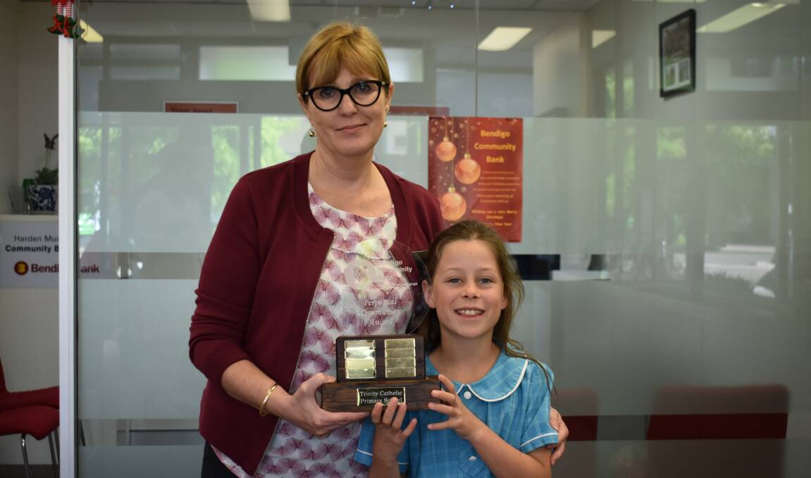 Bendigo Bank  Branch Manager Lisa Dean presents 10 year old Poppy Lucas with the Bendigo Bank Perpetual Community Award Trophy. Picture: Jody Potts