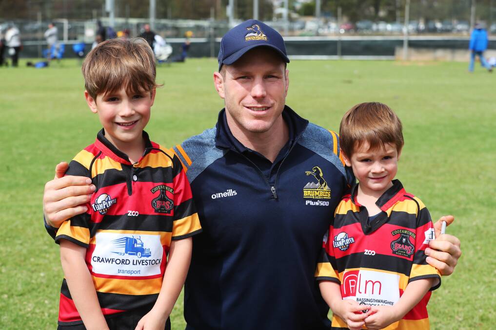 HEADLINE ACT: Brumbies and Wallabies star David Pocock spends time with Hamish Clark, 7 and Digby Clark, 5..