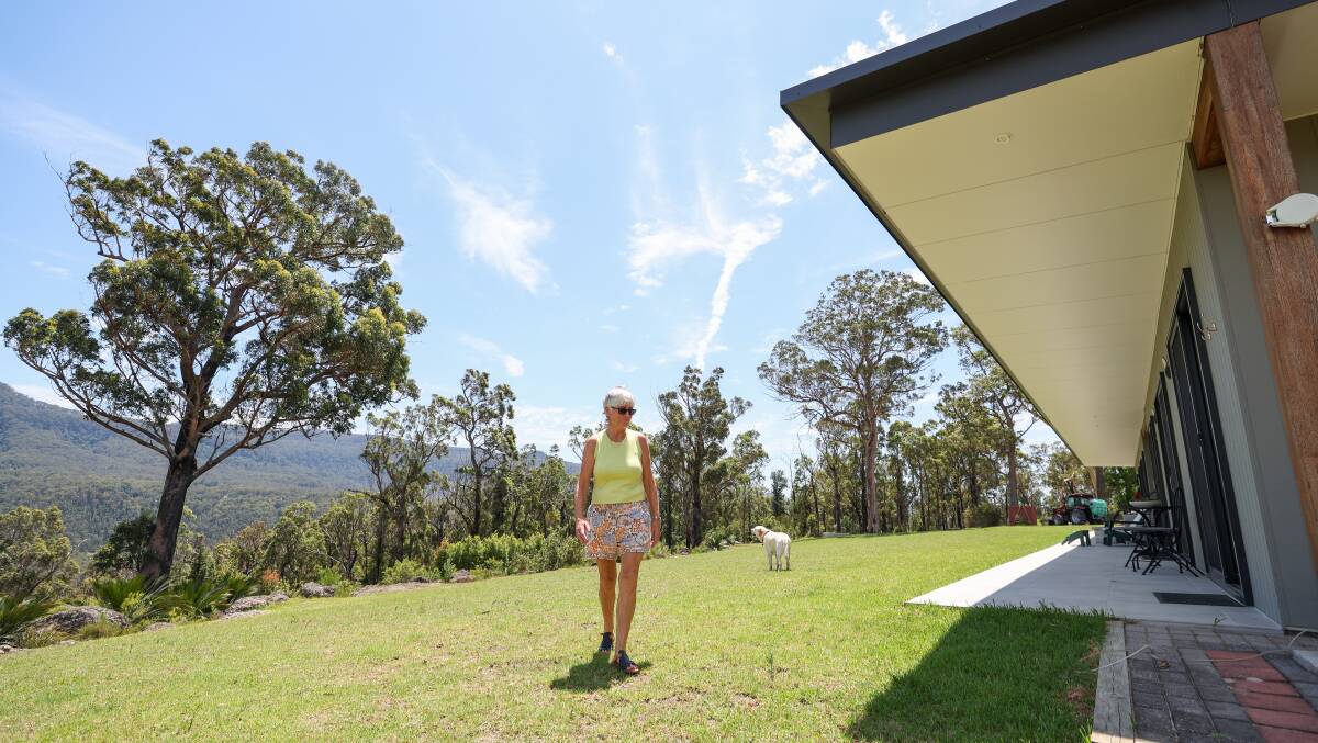 Alison Baker on her Bankia Park holiday property, where regrowth makes it hard to tell where the fire went through. Picture by Adam McLean Alison Baker on her Bankia Park holiday property, where regrowth makes it hard to tell where the fire went through. Picture by Adam McLean
