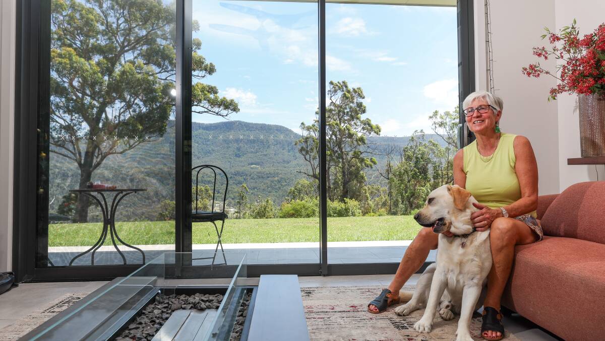 Alison Baker with her labrador Sam in their newly built home in Kangaroo Valley, looking out over the river where the January 4, 2020 bushfire headed after it destroyed her property. Picture by Adam McLean.
Below far left: A drone photo on a guest book which captured Bankia Park Cottages in the days after January 4, 2020. Below left: Maddisons in the Valley worker Marijke Parker. Picture by Robert Peet Alison Baker with her labrador Sam in their newly built home in Kangaroo Valley, looking out over the river where the January 4, 2020 bushfire headed after it destroyed her property. Picture by Adam McLean.
Below far left: A drone photo on a guest book which captured Bankia Park Cottages in the days after January 4, 2020. Below left: Maddisons in the Valley worker Marijke Parker. Picture by Robert Peet