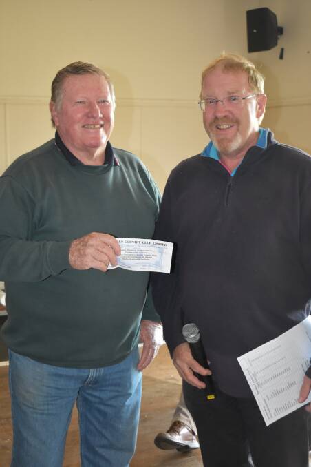 CONGRATULATIONS: Bernie Parker is presented his prize by Craig Filmer at the weekend. Picture: Jody Potts