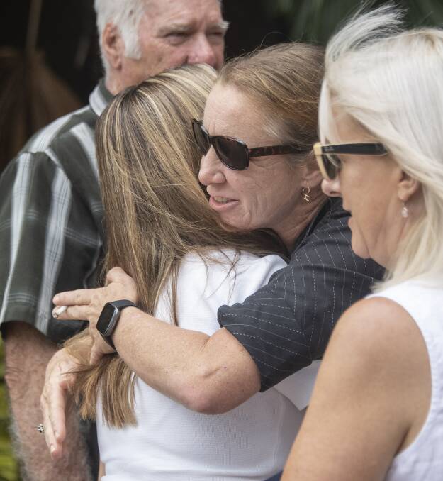 Jayden's aunt Sharelle Harwood hugs his cousin Holly Westcott outside Cairns Coroners Court. Picture: Brian Casey