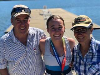 CELEBRATIONS: Jetta Kennett, who was cox in the gold medal-winning team, with her parents Andrew and Michelle. Picture: Supplied