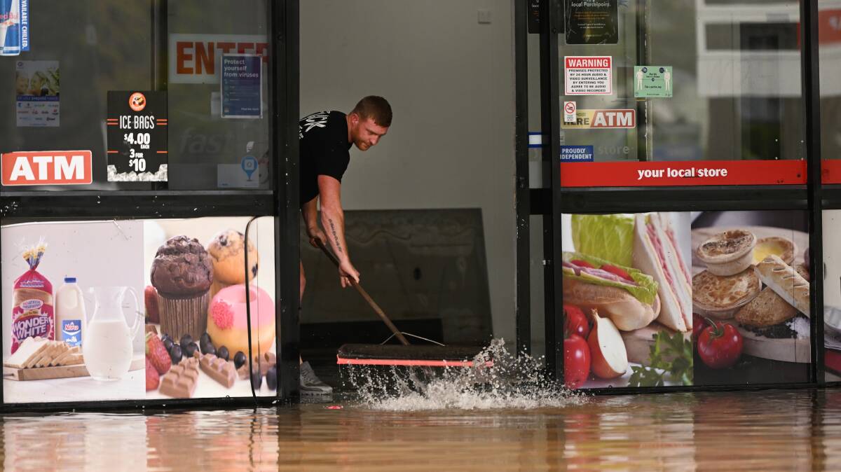 A man begins cleaning up after heavy flooding in Lismore last month. Picture: Getty Images