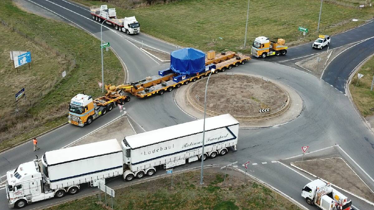 WIDE LOAD: The Wallendbeen roundabout gained plenty of attention on Wednesday with this convoy. The was reportedly hauling mining equipment. Picture: Scott Sanders