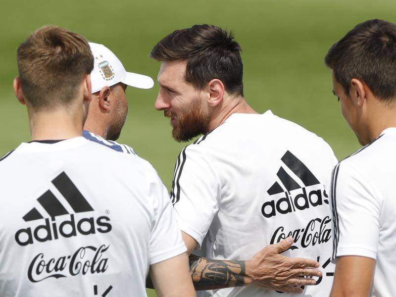Birthday boy Lionel Messi is greeted at training by Argentina coach Jorge Sampaoli.